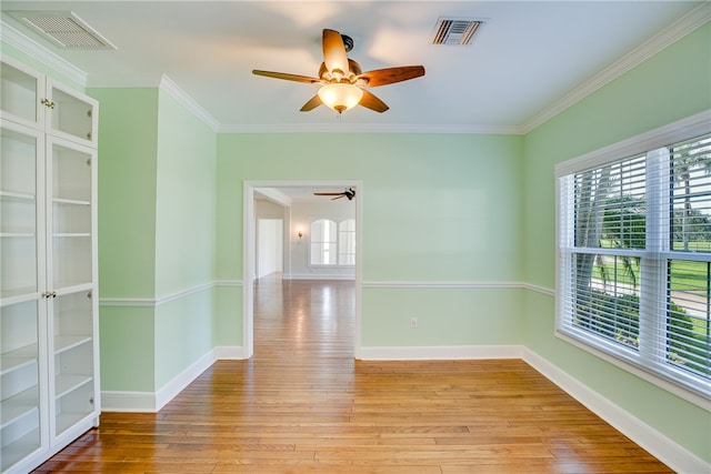 spare room with ceiling fan, light hardwood / wood-style floors, and ornamental molding