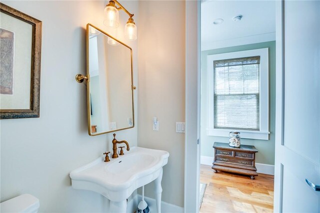 110 Mariner Beach Ln, Vero Beach, FL 32963 - half bath with wood finished floors, toilet, and baseboards