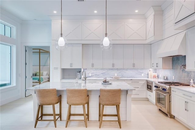 110 Mariner Beach Ln, Vero Beach, FL 32963 - kitchen featuring appliances with stainless steel finishes, a sink, light stone counters, white cabinets, and decorative backsplash