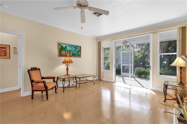 sitting room with ceiling fan, light hardwood / wood-style flooring, and ornamental molding