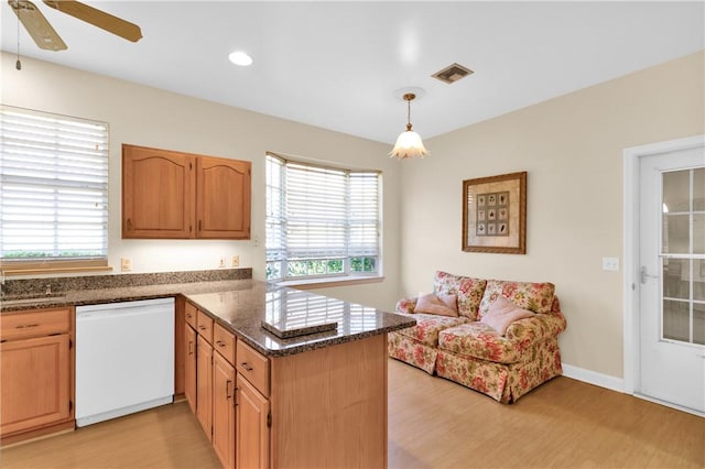 kitchen with light wood-type flooring, dishwasher, plenty of natural light, and kitchen peninsula