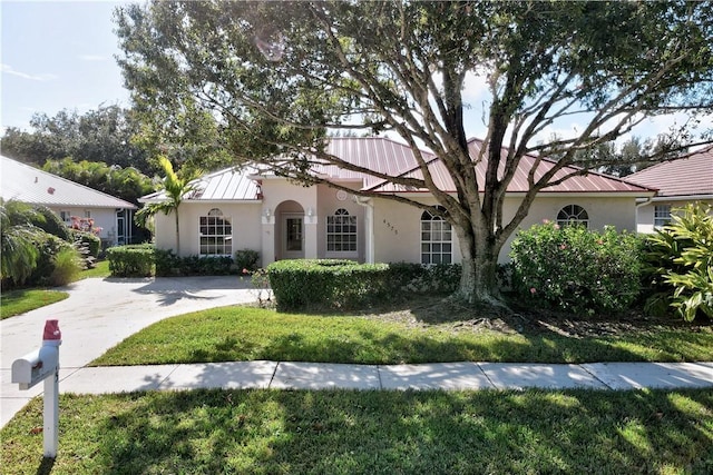 mediterranean / spanish-style home featuring a front yard