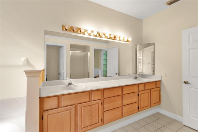 bathroom featuring an enclosed shower, vanity, and tile patterned floors