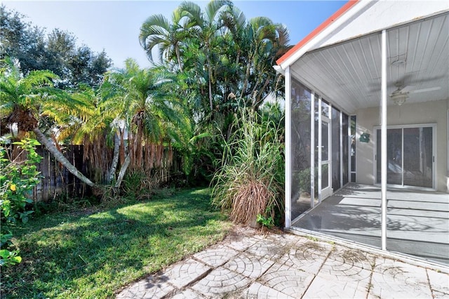 view of yard featuring a sunroom and a patio area