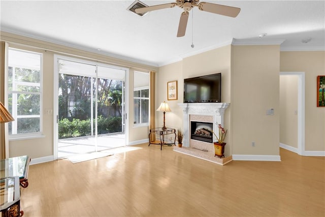 living room featuring ornamental molding, ceiling fan, and light hardwood / wood-style floors