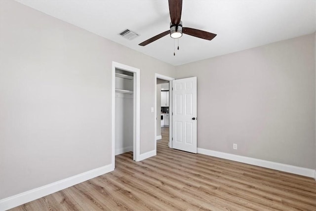 unfurnished bedroom featuring light hardwood / wood-style flooring, a closet, and ceiling fan