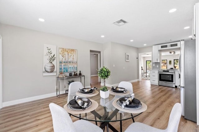 dining area featuring light wood-type flooring