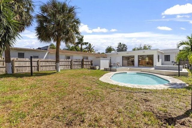 view of pool featuring a lawn