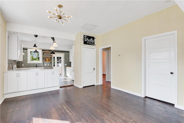 kitchen with white cabinetry, decorative light fixtures, dark wood-type flooring, and decorative backsplash