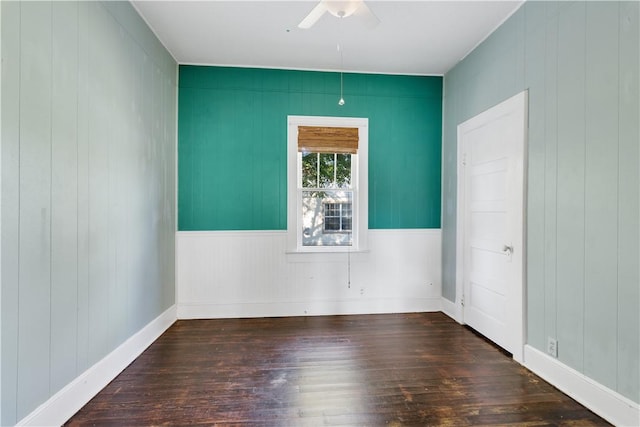 empty room with ceiling fan and dark hardwood / wood-style floors