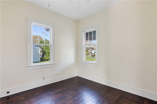 unfurnished room with wood-type flooring