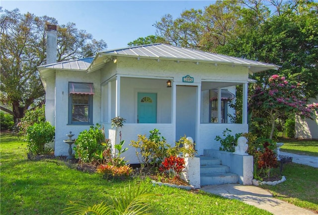 bungalow-style home with a front yard