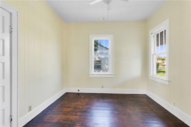 spare room with plenty of natural light, hardwood / wood-style floors, and ceiling fan