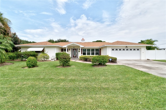 single story home featuring a front lawn and a garage