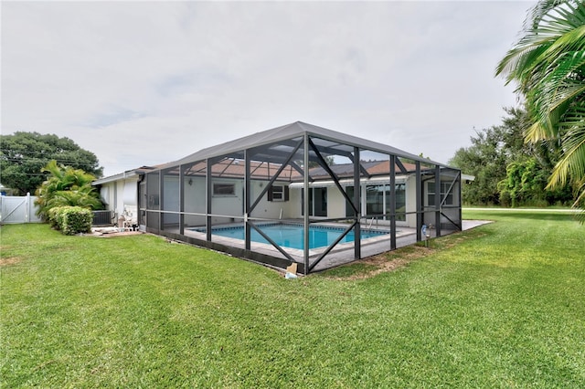 view of pool featuring a patio, a lawn, a lanai, and cooling unit