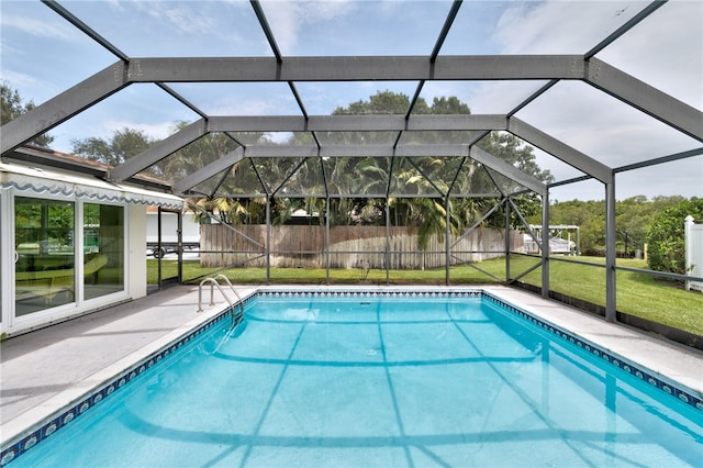 view of swimming pool featuring a lanai, a yard, and a patio area