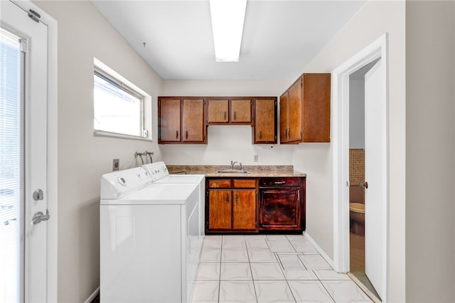 washroom featuring cabinets, sink, and washer and clothes dryer