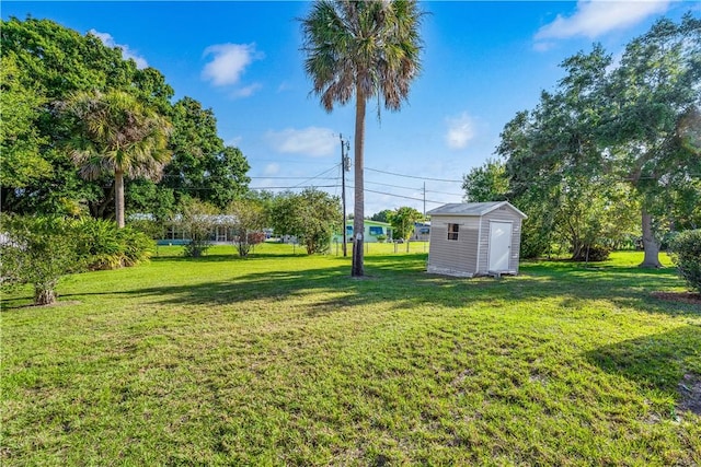 view of yard featuring an outbuilding and a storage shed
