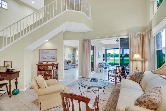 1725 Victoria Cir, Vero Beach, FL 32967 - living area featuring tile patterned flooring, a high ceiling, stairs, and baseboards