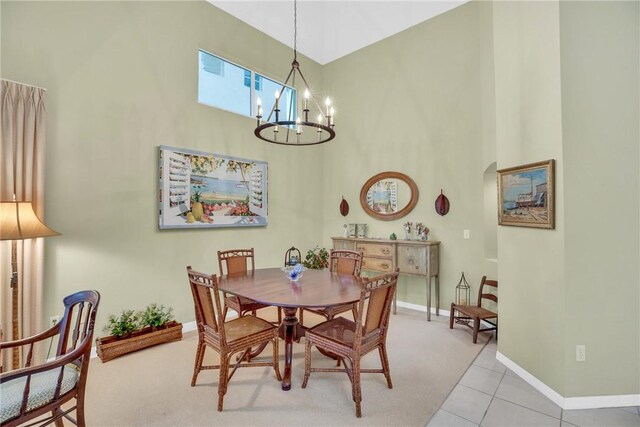 1725 Victoria Cir, Vero Beach, FL 32967 - tiled dining space with a chandelier, arched walkways, a high ceiling, and baseboards