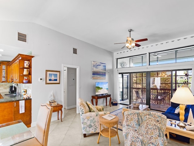 living room featuring lofted ceiling and sink