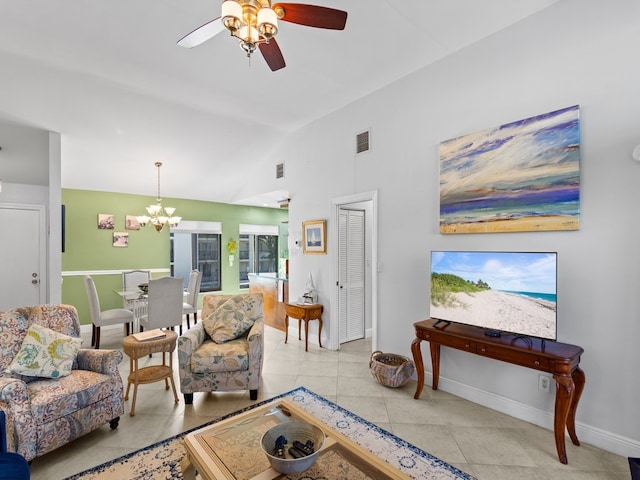 tiled living room with ceiling fan with notable chandelier and vaulted ceiling