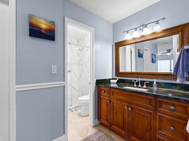 bathroom with tile patterned floors, walk in shower, vanity, ceiling fan, and toilet