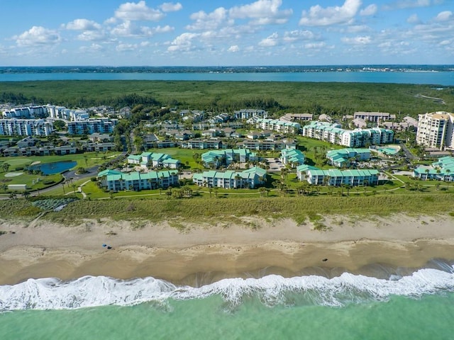 birds eye view of property featuring a water view and a beach view