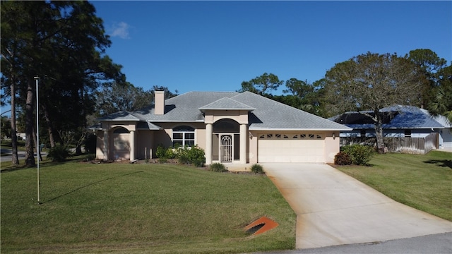 view of front of home with a front yard and a garage