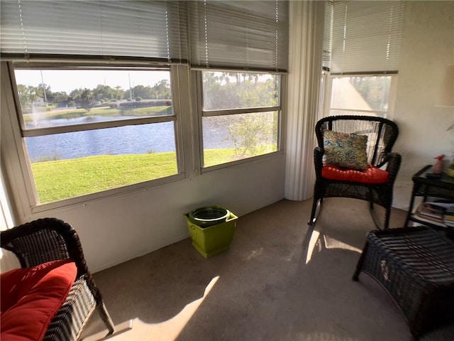 sunroom / solarium featuring a water view