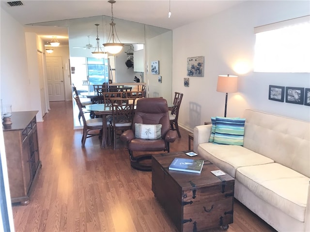 living room featuring vaulted ceiling and hardwood / wood-style flooring