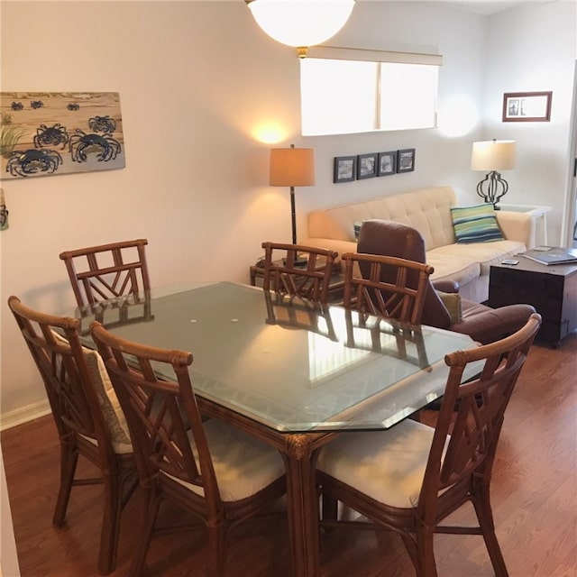 dining space with dark hardwood / wood-style floors