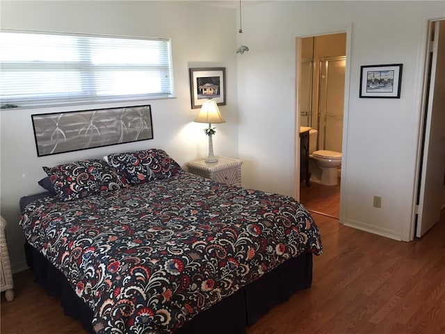 bedroom featuring hardwood / wood-style flooring and ensuite bath