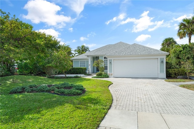 ranch-style home featuring a garage and a front lawn