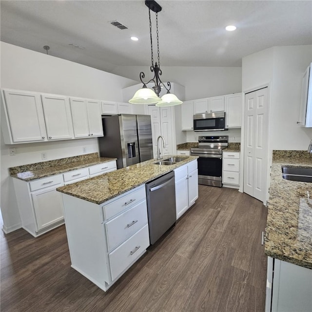 kitchen with pendant lighting, white cabinetry, sink, and appliances with stainless steel finishes