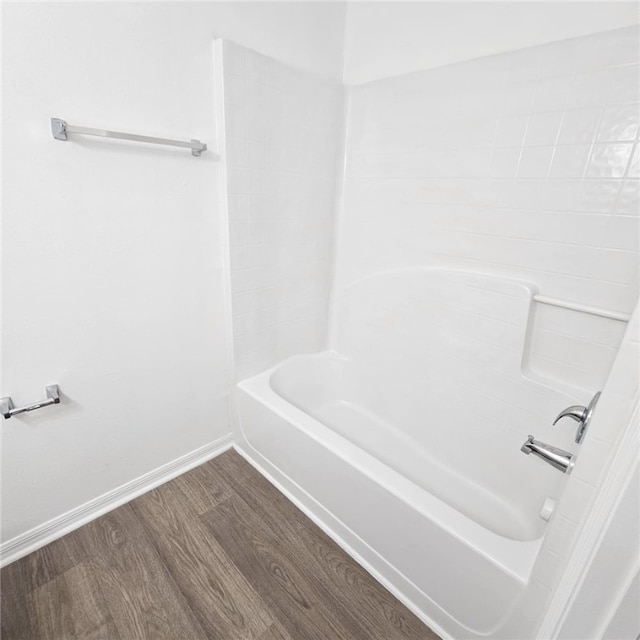 bathroom with wood-type flooring and shower / washtub combination