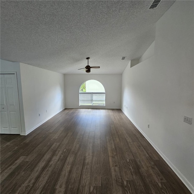 unfurnished room with ceiling fan, dark hardwood / wood-style floors, and a textured ceiling