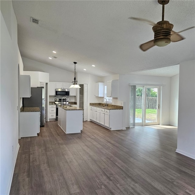 kitchen with stainless steel appliances, dark wood-type flooring, decorative light fixtures, white cabinetry, and an island with sink