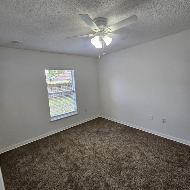 carpeted empty room with ceiling fan and a textured ceiling