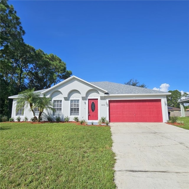 single story home with a garage and a front lawn