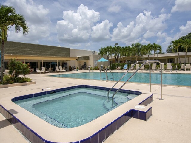 view of swimming pool with a community hot tub and a patio