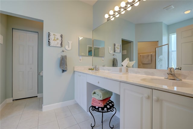 bathroom featuring vanity, walk in shower, and tile patterned floors