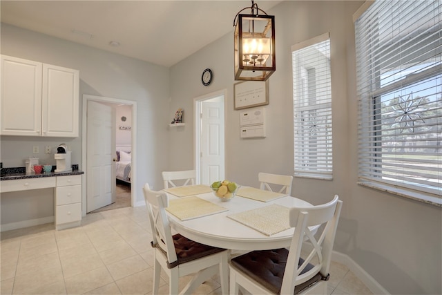 tiled dining space with a chandelier