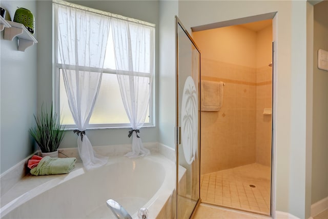 bathroom featuring tile patterned floors and separate shower and tub