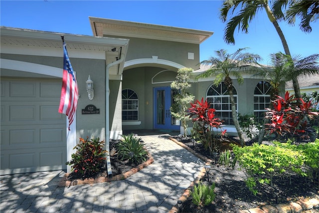 doorway to property with a garage