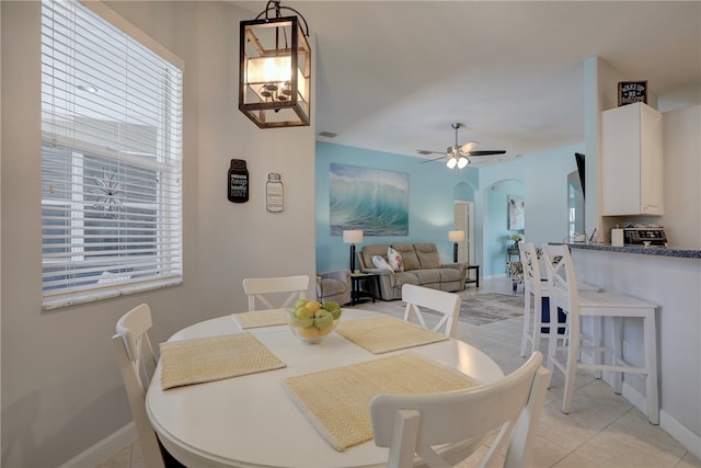 tiled dining space with ceiling fan