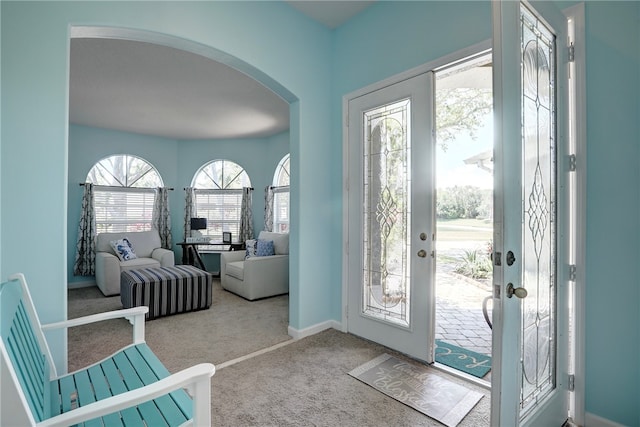 foyer entrance with light colored carpet