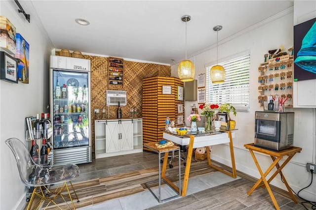 kitchen with built in refrigerator, hanging light fixtures, and ornamental molding