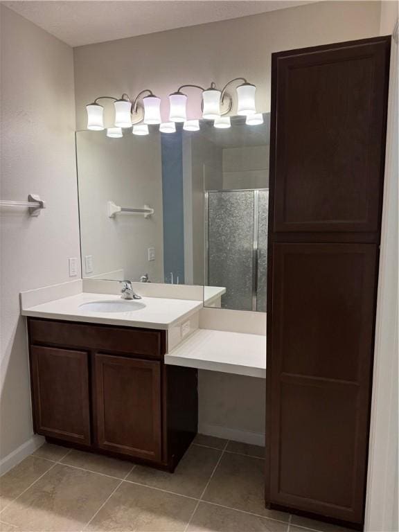 bathroom featuring vanity, tile patterned floors, and a shower with shower door