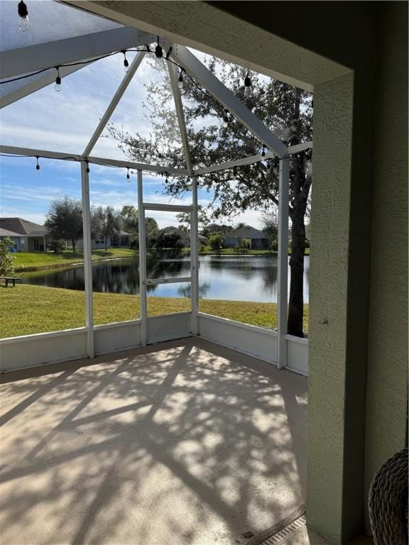 unfurnished sunroom featuring a wealth of natural light and a water view